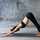 Junge Frau praktiziert Yoga vor urbanem Hintergrund